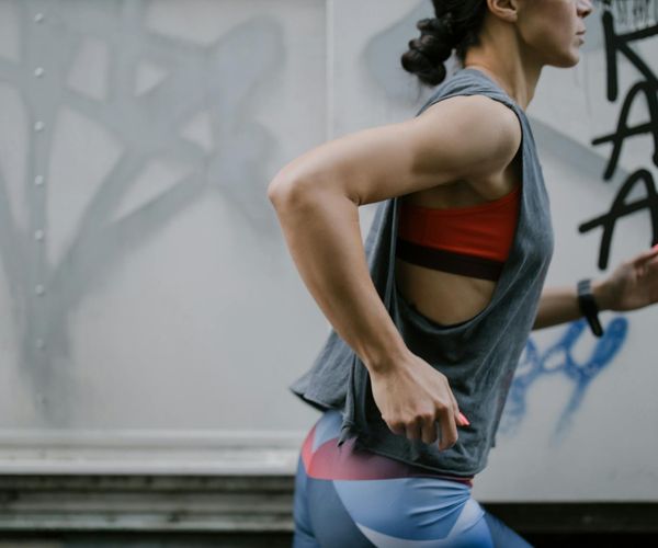 Active woman stretching outdoors, feeling energetic and full of life.