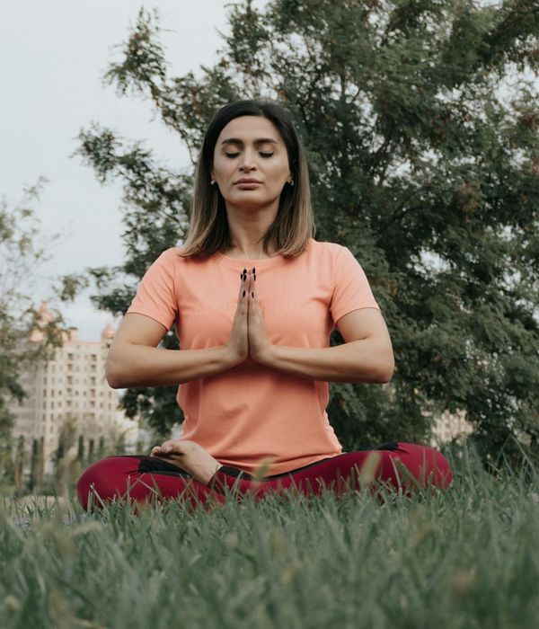 Woman in a calm yoga pose, embodying harmony and balance.